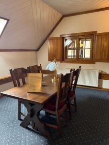 a dining room table with chairs and a lamp on it at Veszprémvölgyi Kúria in Veszprém +23 photos