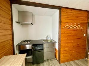 a small kitchen with a sink and a stove at Okas Apartment in Otari