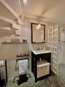 a bathroom with a sink and a mirror at Lacanepière in Générac +24 photos