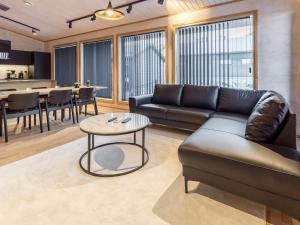 a living room with a couch and a table at Holiday Home Villa plywood by Interhome in Syöte