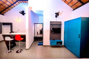 a room with a desk and a red chair at La Vista Resorts in Wayanad