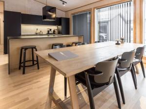 a kitchen and dining room with a wooden table and chairs at Holiday Home Villa plywood by Interhome in Syöte