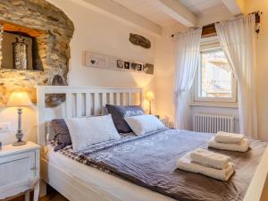 a bedroom with a bed and a stone wall at Holiday Home Casetta Rosa by Interhome in San Siro