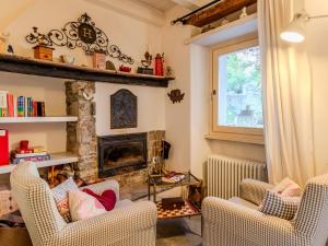a living room with two chairs and a fireplace at Holiday Home Casetta Rosa by Interhome in San Siro