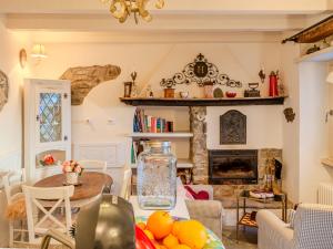 a living room with a table and a fireplace at Holiday Home Casetta Rosa by Interhome in San Siro +21 photos