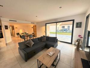 a living room with a couch and a table at Villa Dyane in Salavas