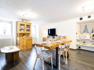 a dining room with a wooden table and chairs at Holiday Home Borgonuovo Waterfall's House by Interhome in Piuro
