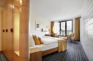 a hotel room with a bed and a desk at Hotel Esplanade Resort & Spa - Adults Only in Bad Saarow +62 photos