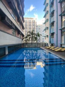 a large swimming pool in the middle of a building at 101 Newport Boulevard Condo in Manila