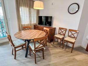 a dining room with a table and chairs and a clock at Apartment Las Pergolas-2 by Interhome in Jávea