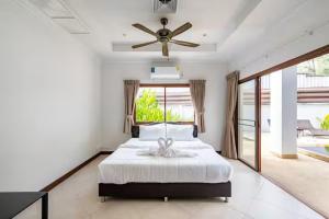 a bedroom with a bed and a ceiling fan at Surin villa by Pattara in Ban Lum Fuang +39 photos