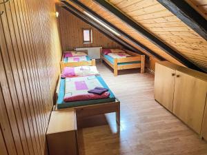 a room with two beds in a attic at Holiday Home Švýcarský dvůr by Interhome in Janske Lazne