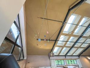 a room with windows and a ceiling with a chandelier at Chalet Glamping in der Orangerie by Interhome in Heyda