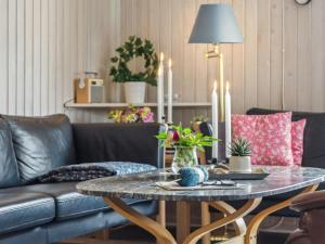 a living room with a table and a couch at Holiday Home Blomma - 300m from the sea by Interhome in Humble