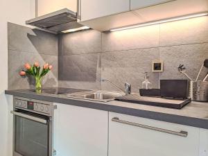 a kitchen with a sink and a counter at Apartment Arolla R01 by Interhome in Champex