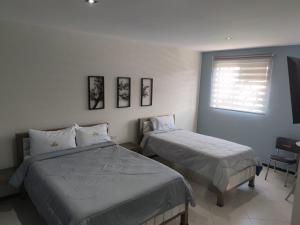 Letto o letti in una camera di Hotel Ocean Fusagasuga