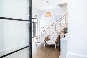 a hallway with chairs and stairs in a house at Hotel Casa Dalia by Blossom Hotels in Marbella