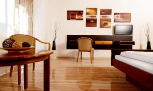 a bedroom with a desk and a table and a bed at Hotel Es Lämmche in Breuberg
