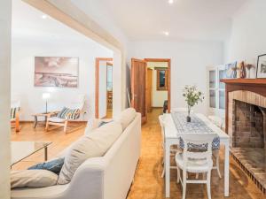 a living room with a white couch and a table at Holiday Home Villa Sa Rapita by Interhome in Sa Ràpita