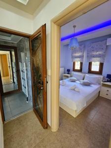 a bedroom with a bed and a walk in shower at Lilian Luxury Villa Halkidiki in Nea Fokea +72 photos