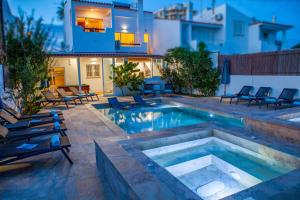 a swimming pool with chairs and a house at Villa Palancar by Algarve Vacation in Albufeira