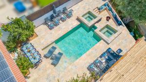 an overhead view of a swimming pool with chaise lounges at Villa Palancar by Algarve Vacation in Albufeira +42 photos