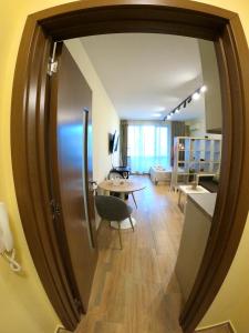 a living room with a table and a large mirror at Salt Lake Studio in Pomorie