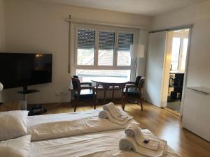 a bedroom with a bed and a table with chairs at Big studio city center - Marble 5 in Zurich