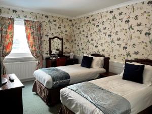 Postel nebo postele na pokoji v ubytování Ramnee Hotel