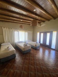 two beds in a large room with windows at Hacienda ALTO MONTE in San Rafael +64 photos