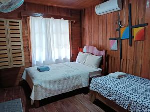 Postel nebo postele na pokoji v ubytování Loma Partida Aqua Lodge