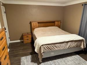 a small bedroom with a bed and a dresser at The Gather Grove in Toledo