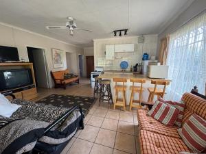 a living room with a couch and a kitchen at Porcupine Place in Denysville