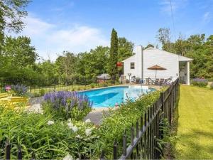a swimming pool in a yard with a fence at Back Inn Time in Fairfax
