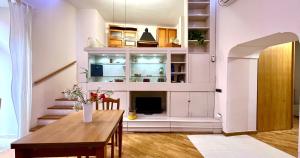 a living room with a table and a fireplace at Sweet home Pozzuoli in Pozzuoli
