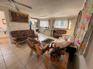 a living room with a couch and a table at Porcupine Place in Denysville