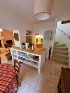 a kitchen with a counter and a table in a room at La Maison de Piolon in Beaumont-du-Ventoux +19 photos