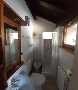 Łazienka z białą toaletą i umywalką w obiekcie Residence Les Lacs w mieście Bardonecchia +36 zdjęć