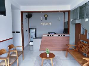 a lobby with chairs and a table and a counter at Hillway Boutique Resort in Vythiri