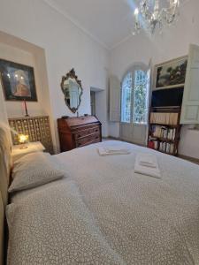 a bedroom with a large bed with two towels on it at Secret villa's city garden in Perugia
