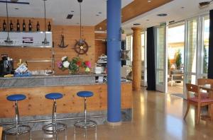 a kitchen with a bar with blue stools at Boutique Hotel Fähri Gersau in Gersau