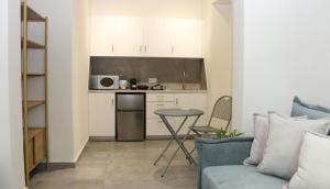 a kitchen with a couch and a table in a room at Pirgos Cozy Apartment for 4 by MPS in Pyrgos