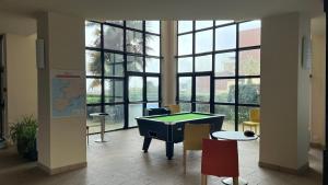 a room with a pool table in front of windows at Trestraou 217 in Perros-Guirec