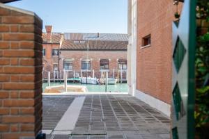 a view of a canal between two brick buildings at Venetian Dreams - Giudecca in Venice