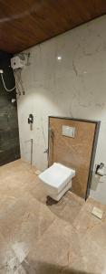 a bathroom with a white toilet in a room at Vistara Residency in Navi Mumbai +7 photos