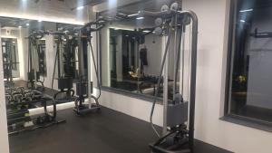 a fitness room with a row of gym equipment at Cozy flat Азур in Saints Constantine and Helena