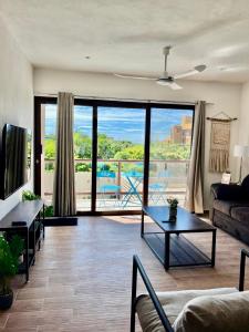 a living room with a view of the ocean at Mar y Chelo Luxury Aparments in Isla Mujeres