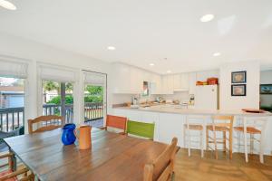 a kitchen and dining room with a wooden table and chairs at Beach House in Saint Simons Island
