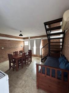 a living room with a table and a bunk bed at Complejo Puesta del Sol san Luis in La Punta