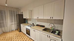 a kitchen with white cabinets and a sink at The birds nest in Tbilisi City